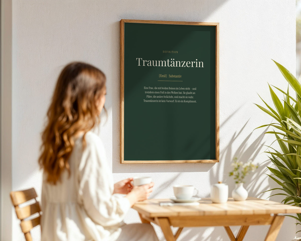 "Traumtänzerin" (Definition) – framed poster held in hand